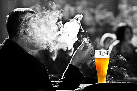 Mann raucht. Gesicht verdeckt durch den Rauch. Vor ihm steht ein gefülltes Weizenbierglas. Quelle: https://pixabay.com/de/
